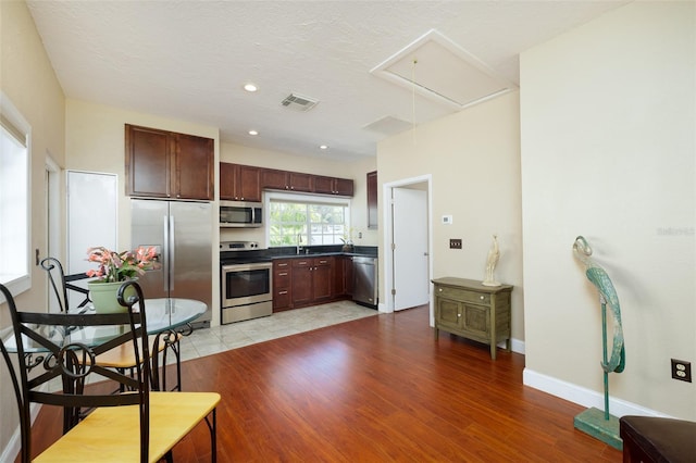 kitchen with appliances with stainless steel finishes and light wood-type flooring