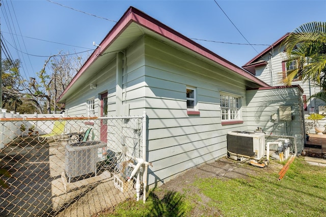 view of side of home with central AC and a patio area