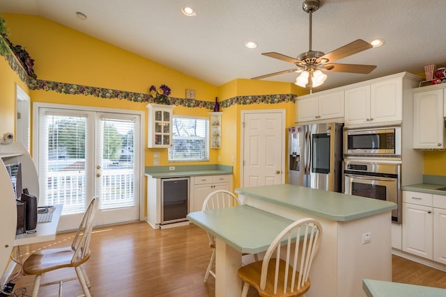 kitchen featuring wine cooler, white cabinets, and appliances with stainless steel finishes