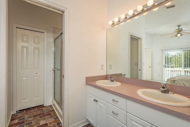 bathroom featuring ceiling fan, vanity, and an enclosed shower