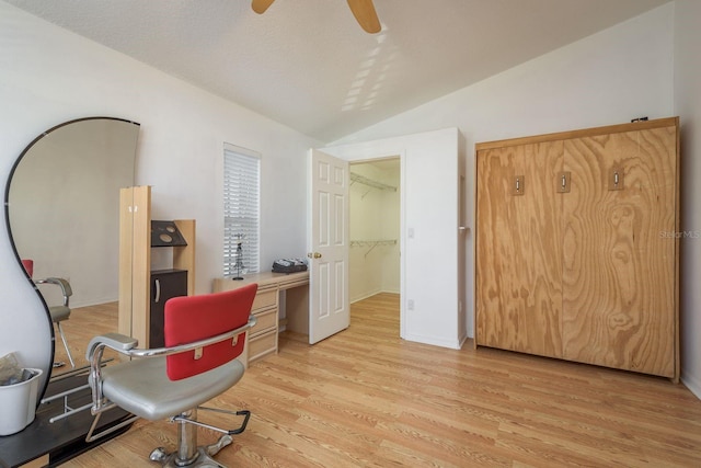 office with vaulted ceiling, a textured ceiling, ceiling fan, and light hardwood / wood-style floors