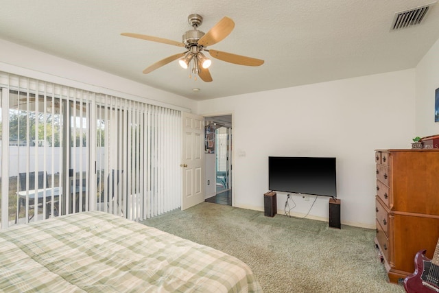 bedroom featuring ceiling fan, carpet floors, and a textured ceiling