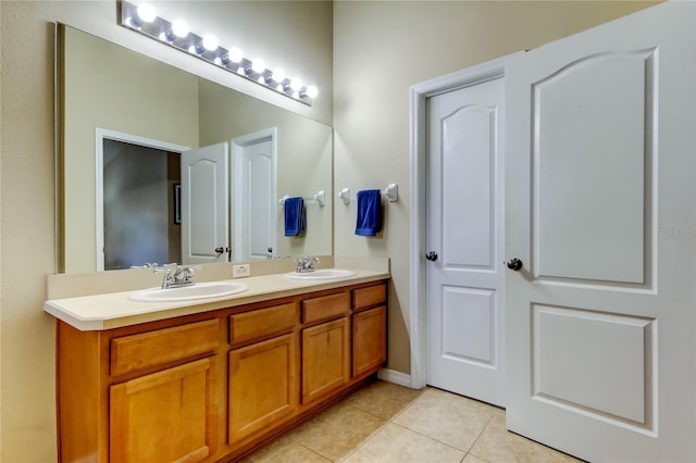 full bathroom featuring double vanity, a sink, and tile patterned floors