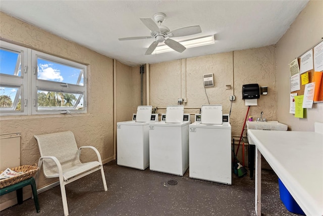 laundry room with sink, washing machine and dryer, and ceiling fan