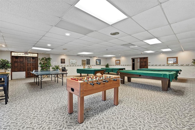 recreation room with carpet, a paneled ceiling, and billiards