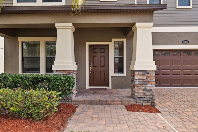 view of exterior entry with a porch