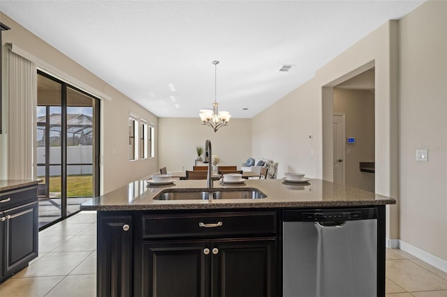 kitchen with sink, light tile patterned floors, dishwasher, hanging light fixtures, and a center island with sink