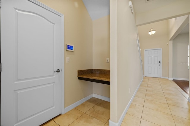 hall with light tile patterned floors