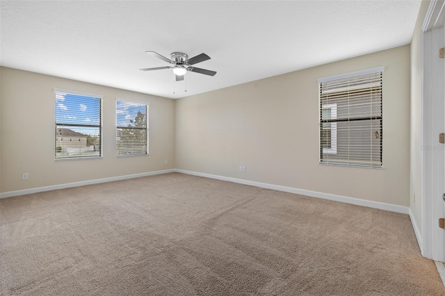 unfurnished room featuring light carpet and ceiling fan