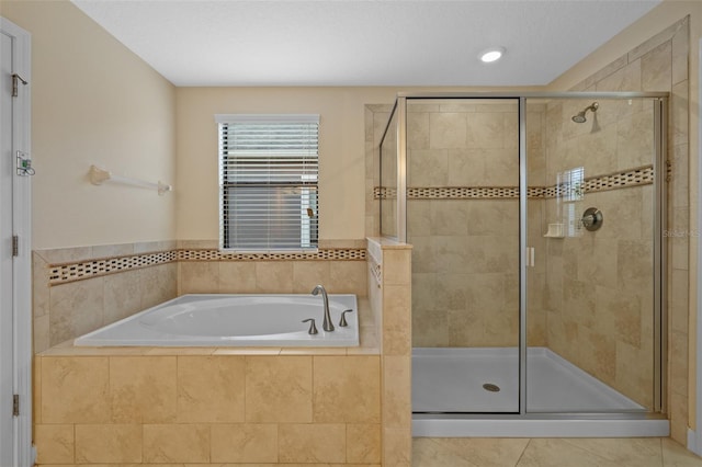 bathroom with shower with separate bathtub and tile patterned floors