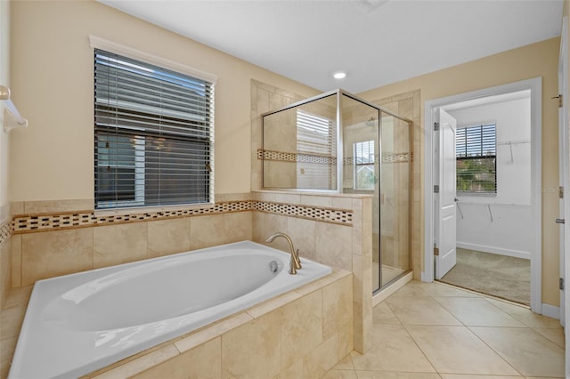 bathroom featuring tile patterned floors and shower with separate bathtub