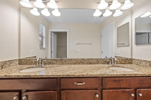 bathroom featuring vanity and a notable chandelier