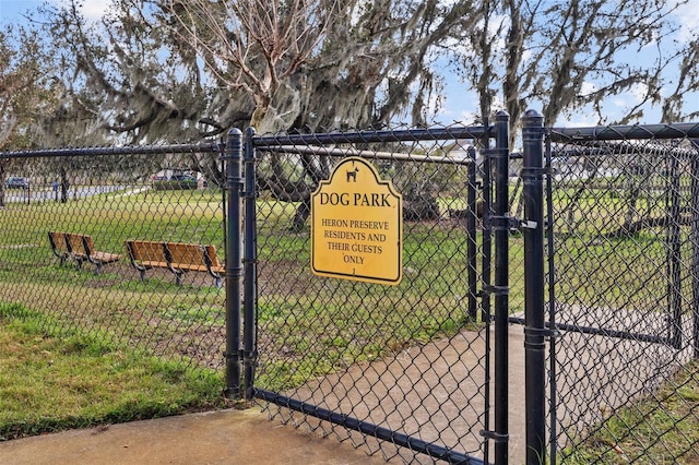 view of gate featuring a lawn