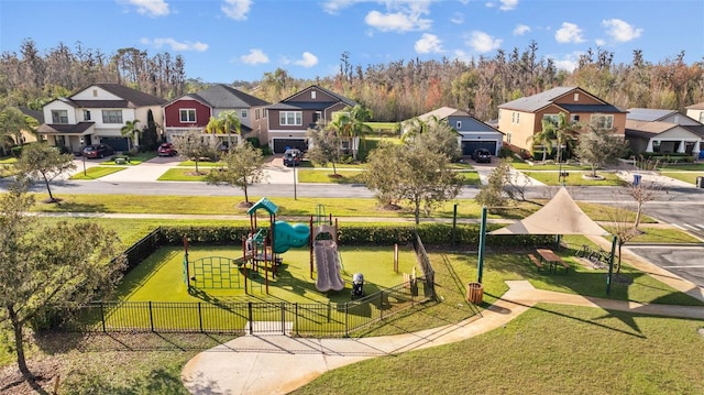 view of home's community with a lawn and a playground