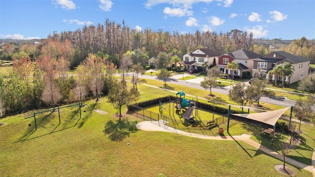 view of home's community with a playground and a yard