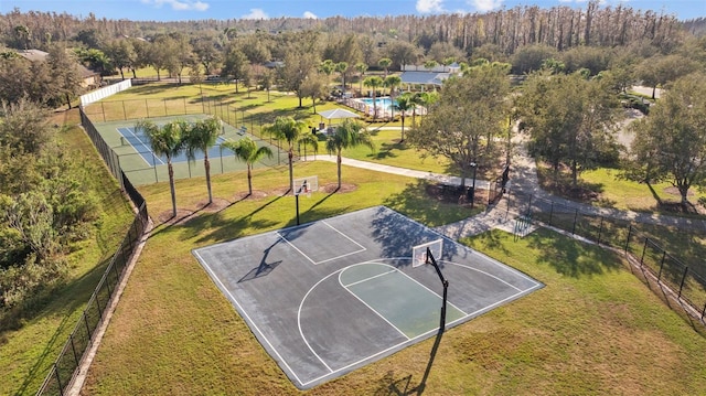 view of sport court featuring a yard