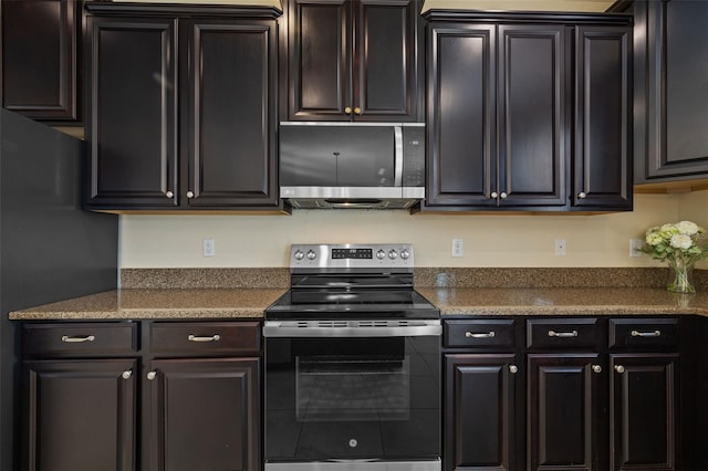 kitchen featuring stainless steel appliances and dark brown cabinets