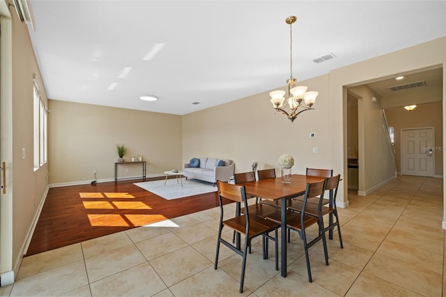 19429 Paddock View Dr, Tampa, FL 33647 - dining area featuring a chandelier, light tile patterned floors, and baseboards