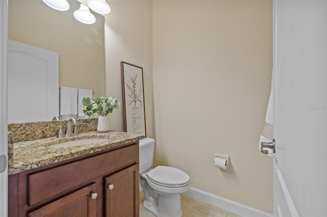 19429 Paddock View Dr, Tampa, FL 33647 - half bath featuring toilet, vanity, tile patterned floors, and baseboards