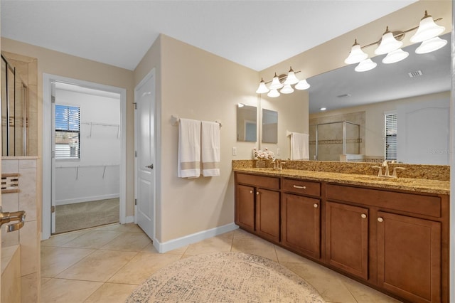 19429 Paddock View Dr, Tampa, FL 33647 - full bathroom featuring a shower stall, double vanity, tile patterned floors, a spacious closet, and baseboards
