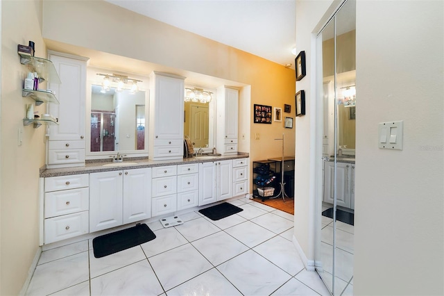 bathroom with tile patterned floors and vanity