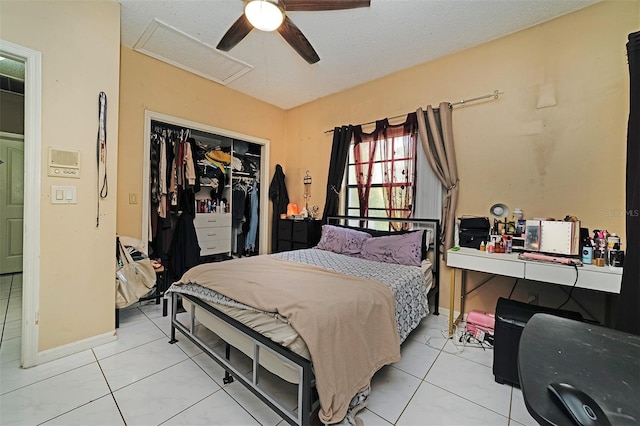 tiled bedroom with ceiling fan and a closet