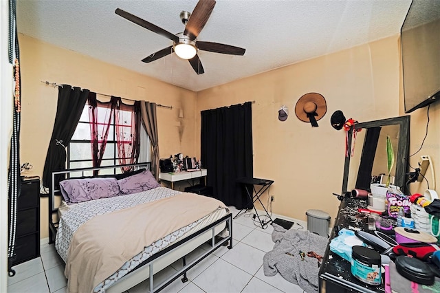 tiled bedroom featuring ceiling fan and a textured ceiling