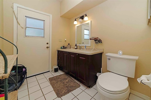 bathroom featuring vanity, toilet, and tile patterned flooring