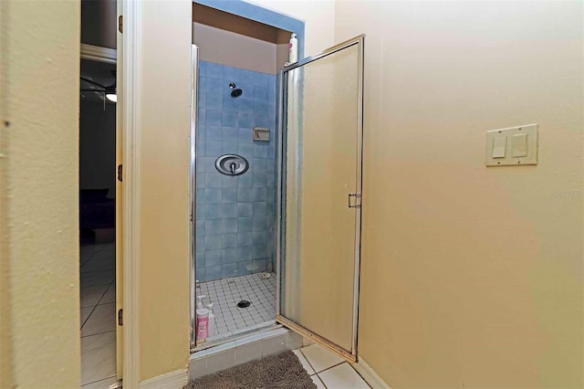 bathroom with tile patterned flooring and a shower with shower door