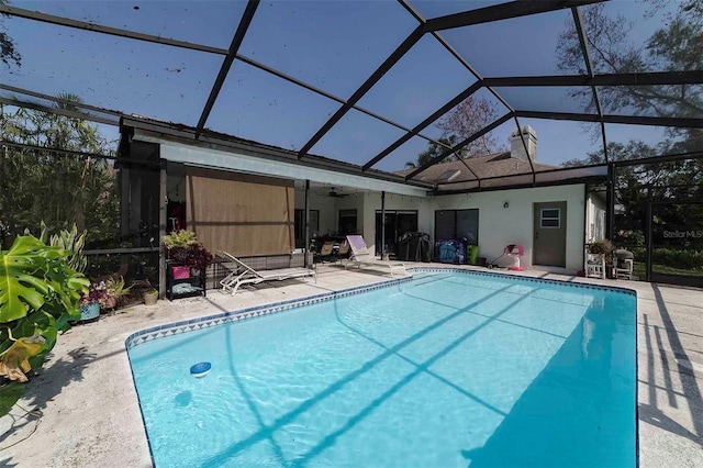 view of swimming pool with a lanai and a patio