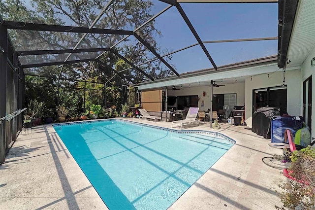 view of swimming pool featuring a patio, a lanai, and ceiling fan