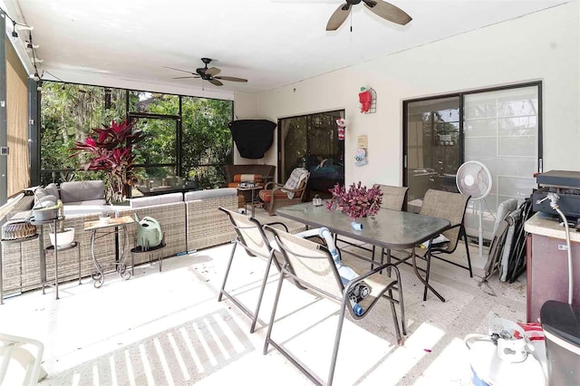 sunroom / solarium featuring ceiling fan