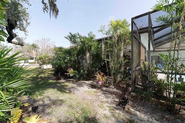 view of yard featuring glass enclosure