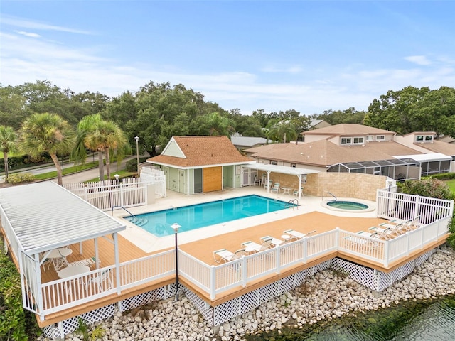 view of pool featuring a hot tub, a gazebo, an outdoor structure, and a deck with water view