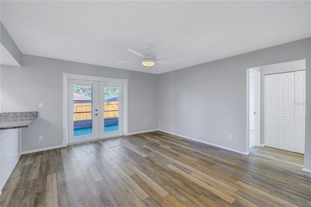 unfurnished living room featuring hardwood / wood-style floors, ceiling fan, and french doors