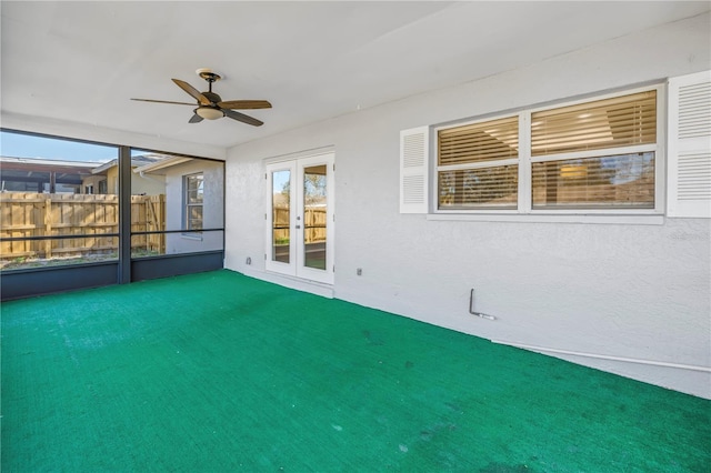 unfurnished sunroom with french doors and ceiling fan