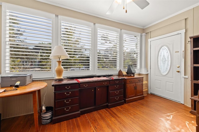 entryway featuring crown molding, a wealth of natural light, and light hardwood / wood-style flooring