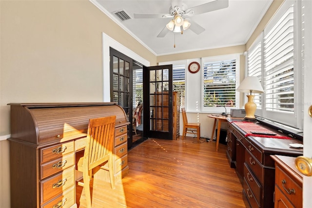 home office with ornamental molding, ceiling fan, and light hardwood / wood-style flooring