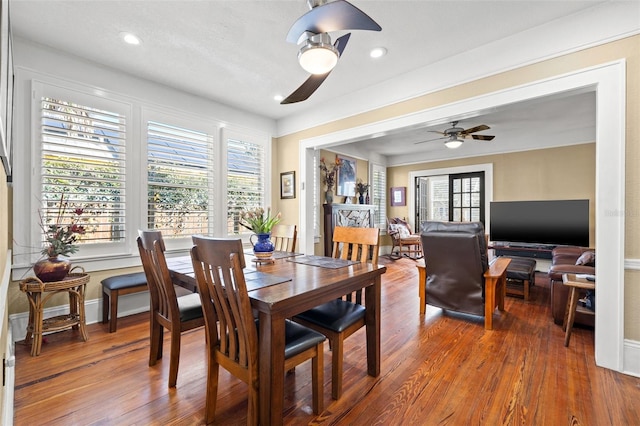 dining space with hardwood / wood-style floors, a wealth of natural light, and ceiling fan