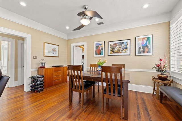 dining space featuring ornamental molding, dark hardwood / wood-style floors, and ceiling fan