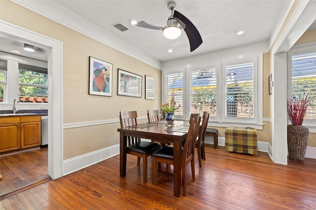 dining room featuring ceiling fan, dark hardwood / wood-style flooring, and sink