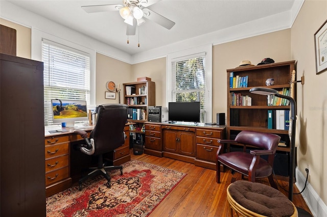 office area featuring ceiling fan, a healthy amount of sunlight, and light wood-type flooring