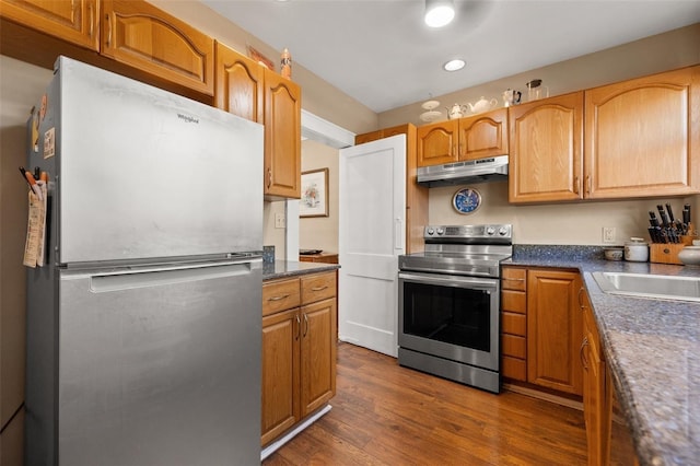 kitchen with stainless steel appliances, dark hardwood / wood-style floors, and sink