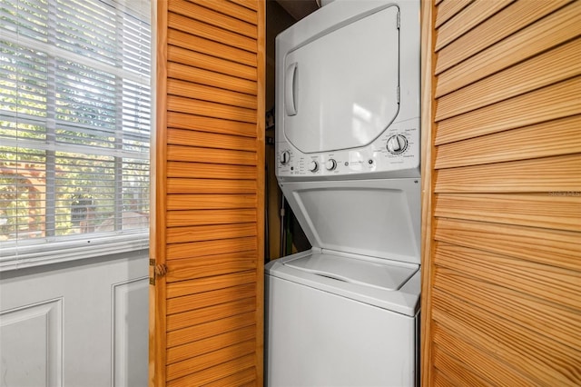 laundry room featuring stacked washer / drying machine