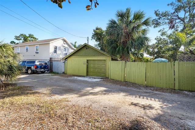 view of side of property with a garage and an outbuilding