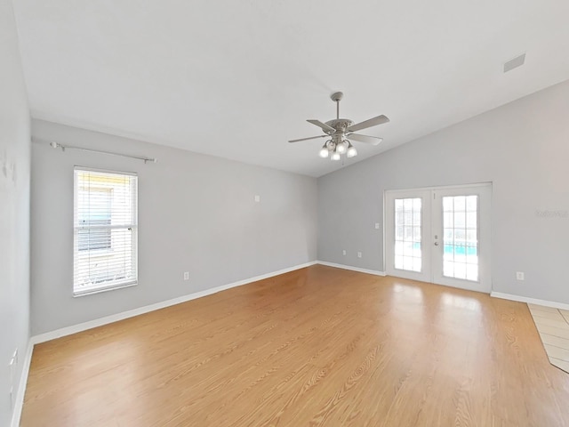 unfurnished room featuring french doors, vaulted ceiling, light wood-style flooring, and baseboards