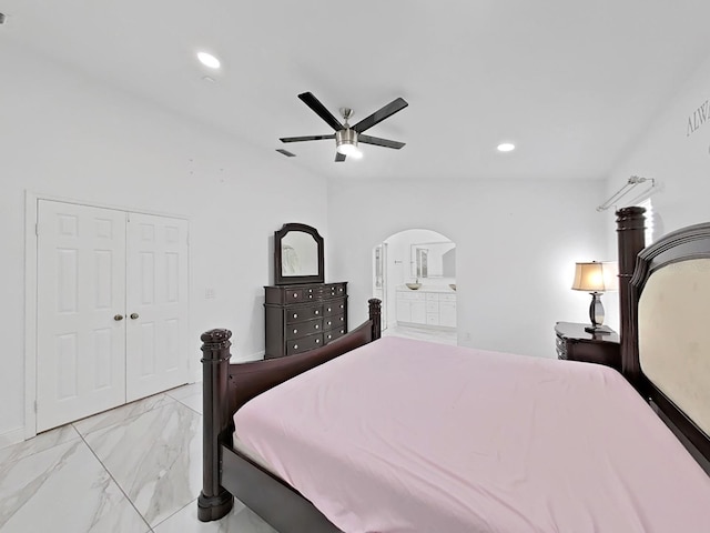 bedroom with arched walkways, recessed lighting, a ceiling fan, marble finish floor, and a closet