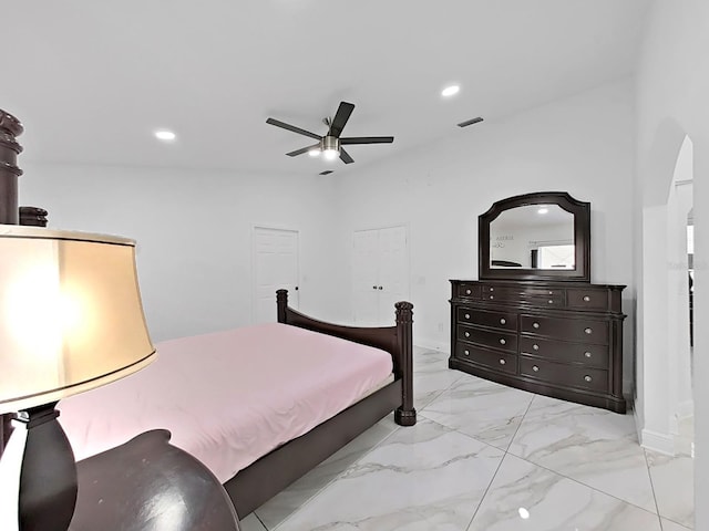 bedroom with arched walkways, marble finish floor, recessed lighting, visible vents, and a ceiling fan