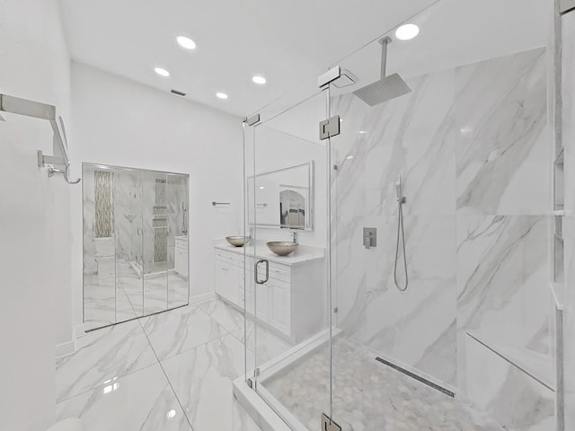 full bathroom with marble finish floor, a marble finish shower, recessed lighting, visible vents, and vanity