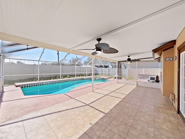 view of swimming pool featuring a patio, a fenced backyard, a lanai, a ceiling fan, and a fenced in pool